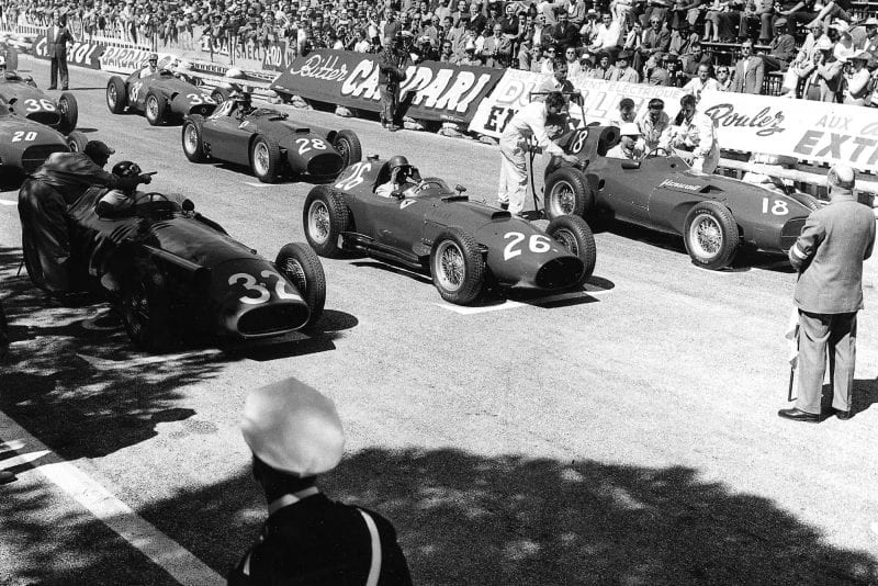 Juan Manuel Fangio (number 32, Maserati 250F), Peter Collins (Lancia-Ferrari D50 801) and Stirling Moss (Vanwall) on the front row of the 1957 Monaco Grand Prix starting grid.