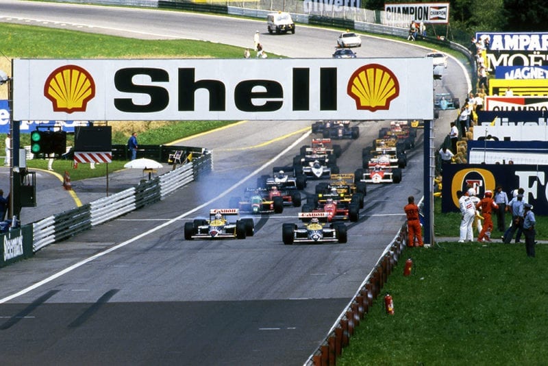 Nelson Piquet, Williams FW11B, and Nigel Mansell, Williams FW11B, lead at the start of the race.