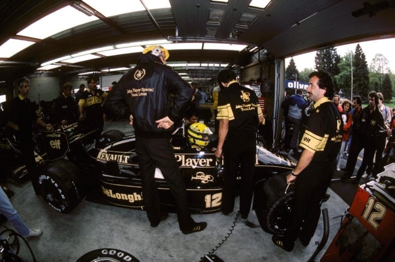 Ayrton Senna sits in the Lotus garage.