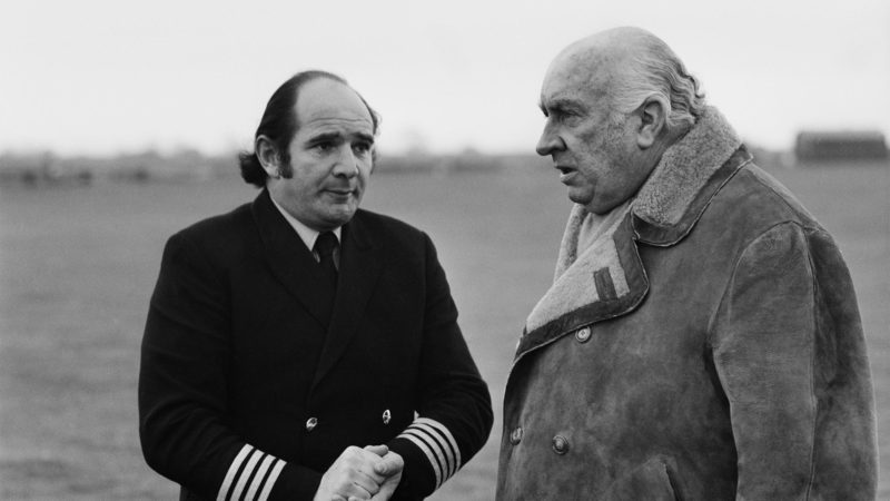 Louis Stanley (1912 - 2004, right), chairman of the Formula One team BRM, with helicopter pilot Ted Malet-Warden during experiments with a helicopter to improve safety for racing drivers during a crash, UK, 25th November 1971. (Photo by Victor Blackman/Daily Express/Getty Images)