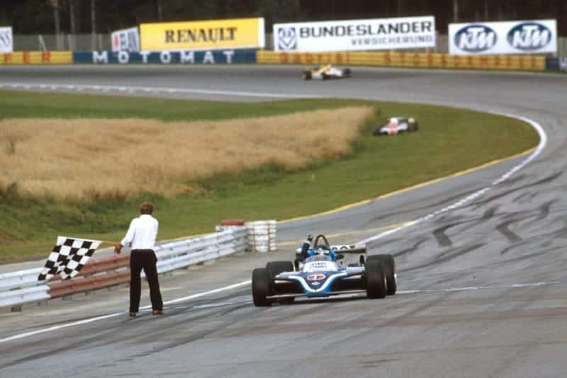 Jacques Laffite in his takes the chequered flag Ligier JS17 Matra for the win.