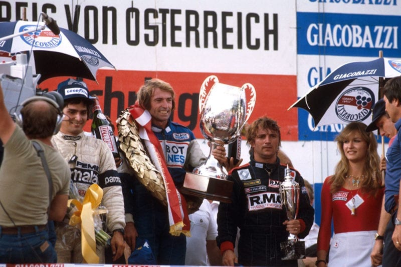 Jacques Laffite, 1st position, Rene Arnoux, 2nd position and Nelson Piquet, 3rd position on the podium.
