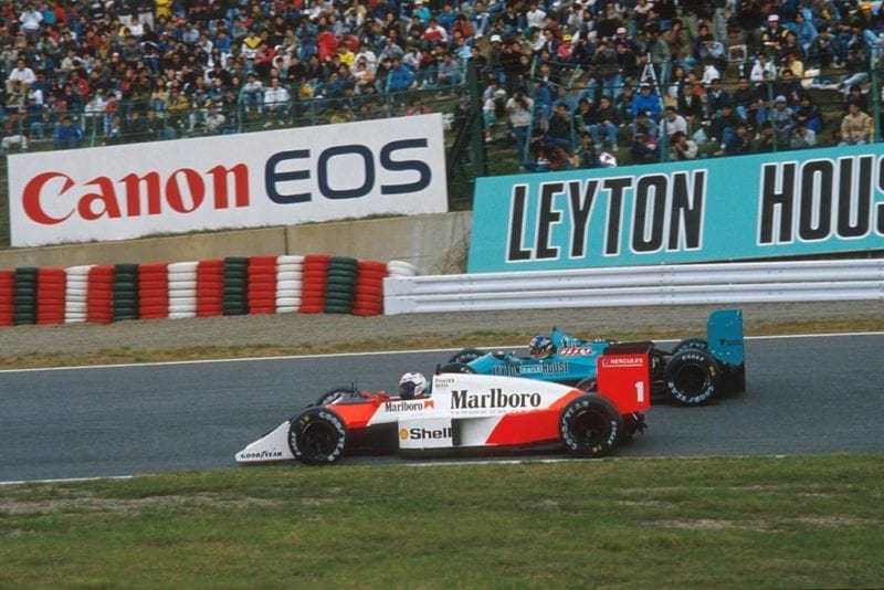 Alain Prost overtakes in his McLaren MP4/3 in the Japanese Grand Prix.