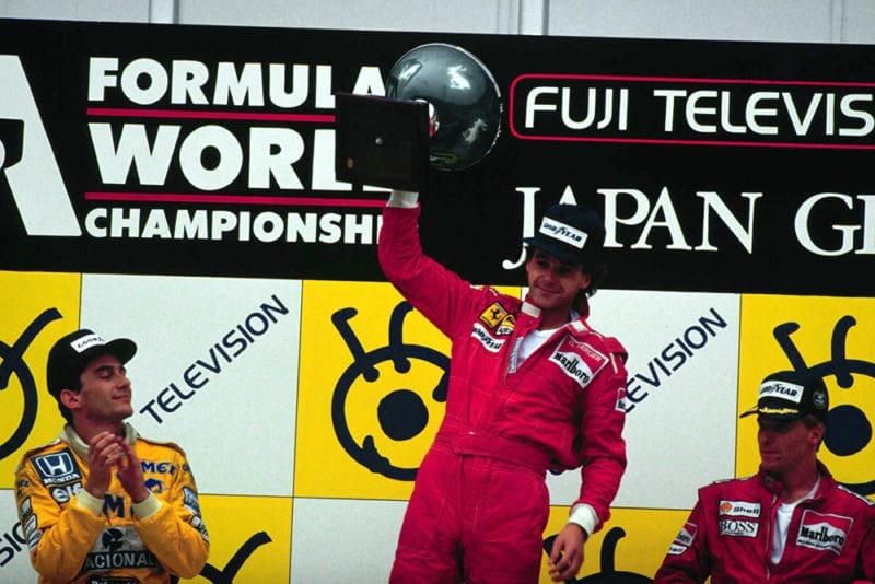 On the podium at Suzuka, Japan, Gerhard Berger, Ayrton Senna and Stefan Johansson celebrate finishing in 1st, 2nd and 3rd positions respectively.