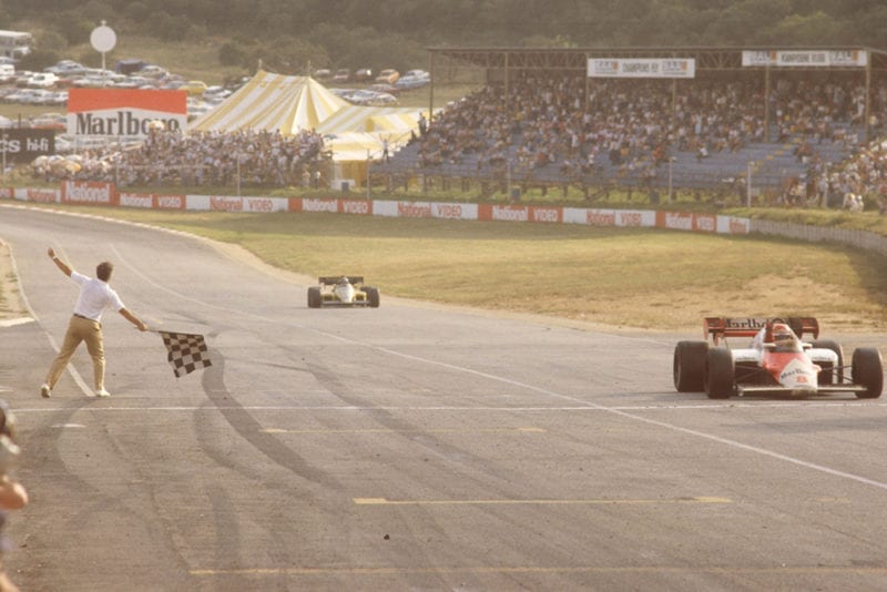 Niki Lauda (McLaren MP42 TAG Porsche) takes the chequered flag.
