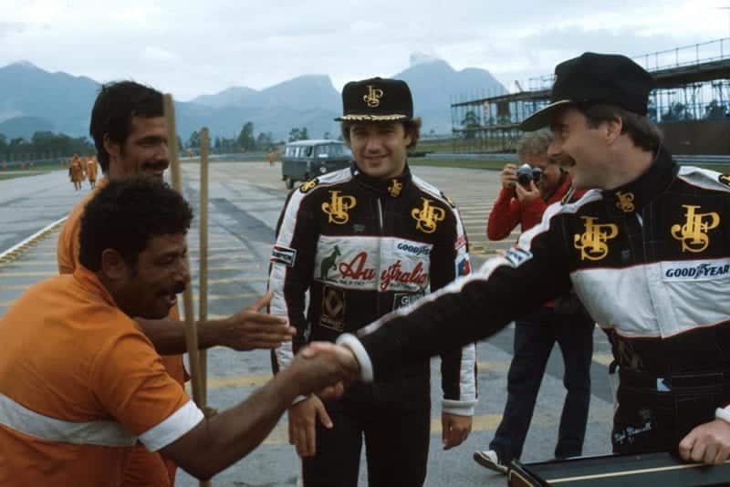 Elio de Angelis, left and Nigel Mansell meet the locals.