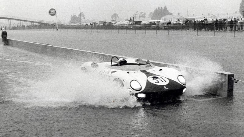 Ferrari 330 P of Pedro Rodriguez and Graham Hill drives through flooded pits at 1965 Sebring 12 Hours