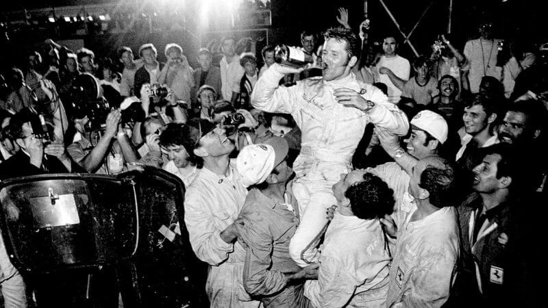 Mario Andretti celebrates victory with a bottle of champagne in 1970 Sebring 12 Hours
