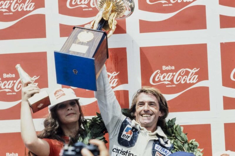 Jacques Laffite (Ligier) celebrates on the podium after winning the 1979 Brazilian Grand Prix.