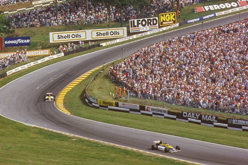 Nelson Piquet leads teammate Nigel Mansell (both Williams FW11 Honda's) around Graham Hill Bend.