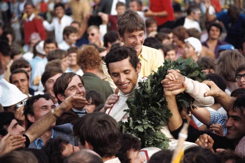 Jacky Ickx is surrounded by fans and press after winning the 1970 Austrian Grand Prix.