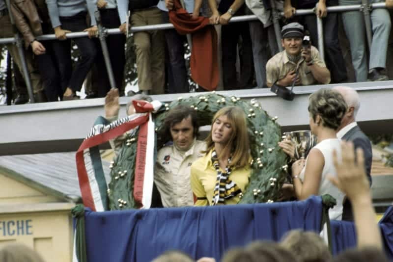 Jackie Stewart celebrates on the podium after winning the 1969 Italian Grand Prix.
