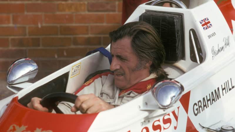 Graham Hill sits in his Hill embassy Racing car 1975