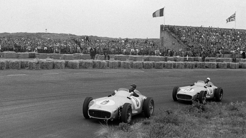 Juan Manuel Fangio, Stirling Moss, Mercedes W196, Grand Prix of the Netherlands, Circuit Park Zandvoort, 19 June 1955. Juan Manuel Fangio ahead of teammate Stirling Moss, driving the unstoppable Mercedes W196, on the way to victory in the 1955 Dutch Grand Prix in Zandvoort where they finished 1-2. (Photo by Bernard Cahier/Getty Images)