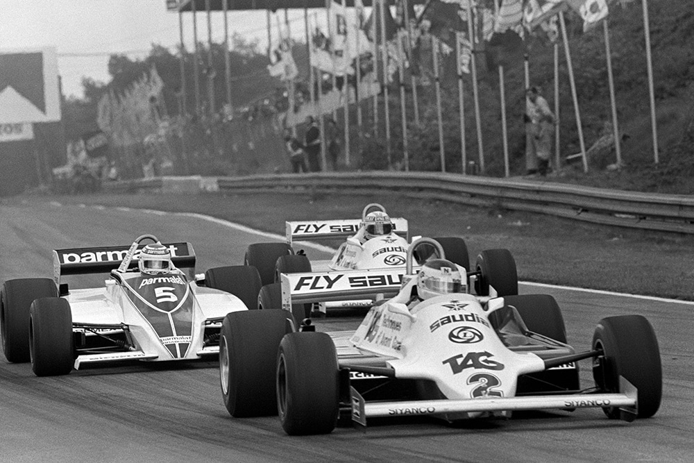 Carlos Reutemann in a Williams FW07C leads Nelson Piquet in his Brabham BT49C and Alan Jones in a Williams FW07C.