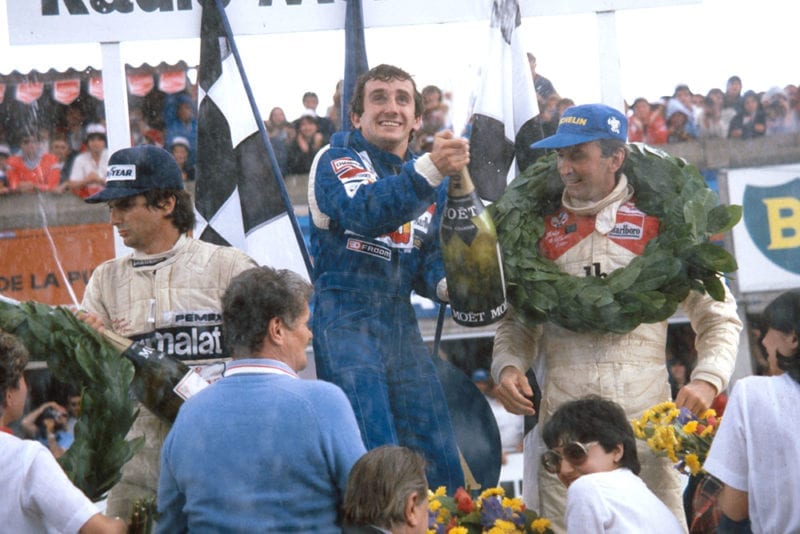 Winner Alain Prost, 2nd placed John Watson and Nelson Piquet in 3rd position on the podium.