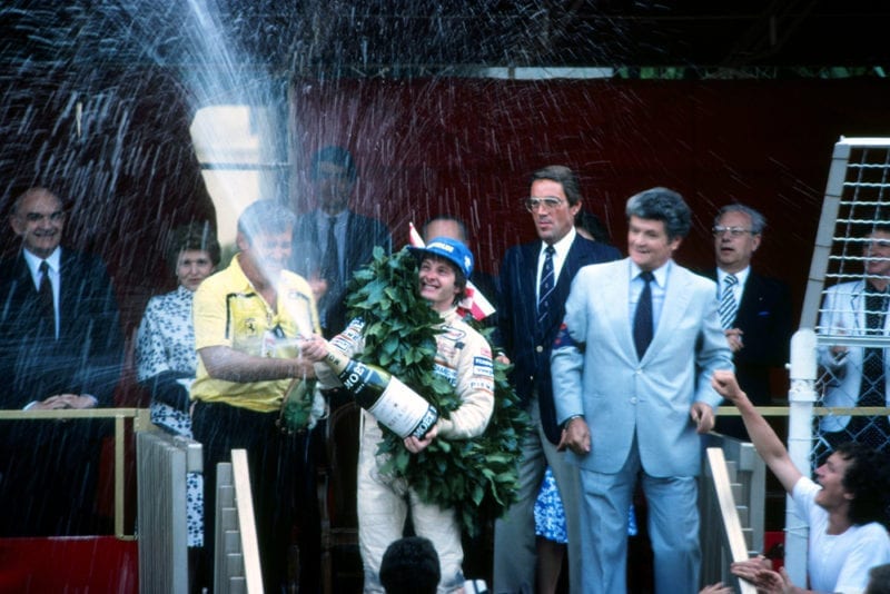 Race winner Gilles Villeneuve sprays the victory champagne on the podium.