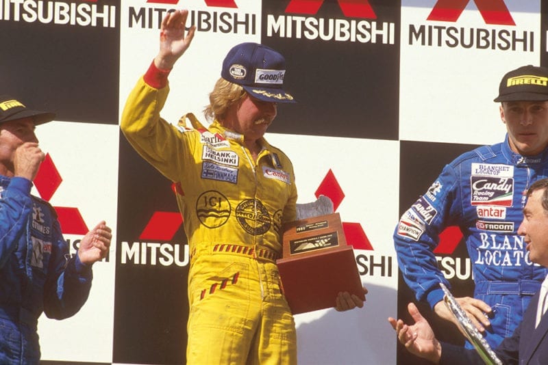 Keke Rosberg, 1st position, Jacques Laffite, 2nd position and Philippe Streiff, 3rd position on the podium.