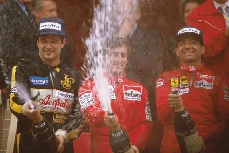 Alain Prost, 1st position, Elio de Angelis, 2nd position and Michele Alboreto, 3rd position on the podium.