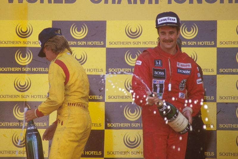 Nigel Mansell, 1st position and teammate Keke Rosberg, 2nd position celebrate on the podium.