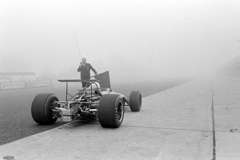 A Brabham BT26 prepares to enter a fog covered Nurburgring.