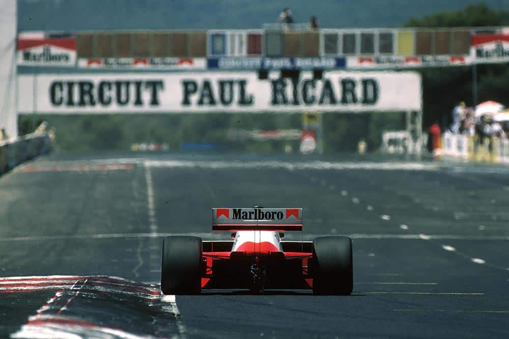 A McLaren heads down the start straight.