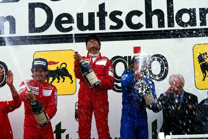 L to R: Alain Prost, 2nd, winner Michele Alboreto and Jacques Laffite, 3rd on the podium.