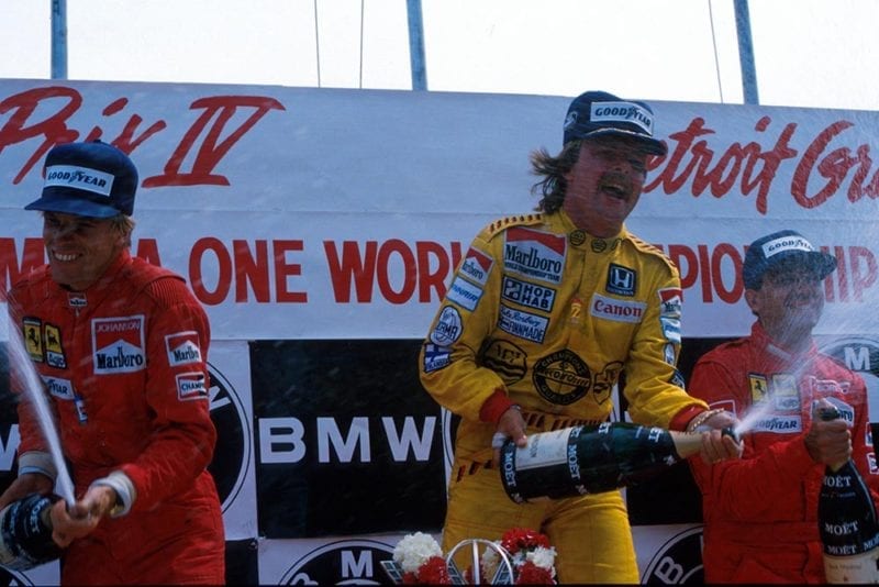 Winner Keke Rosberg celebrates on the podium with Stefan Johansson and Michele Alboreto.