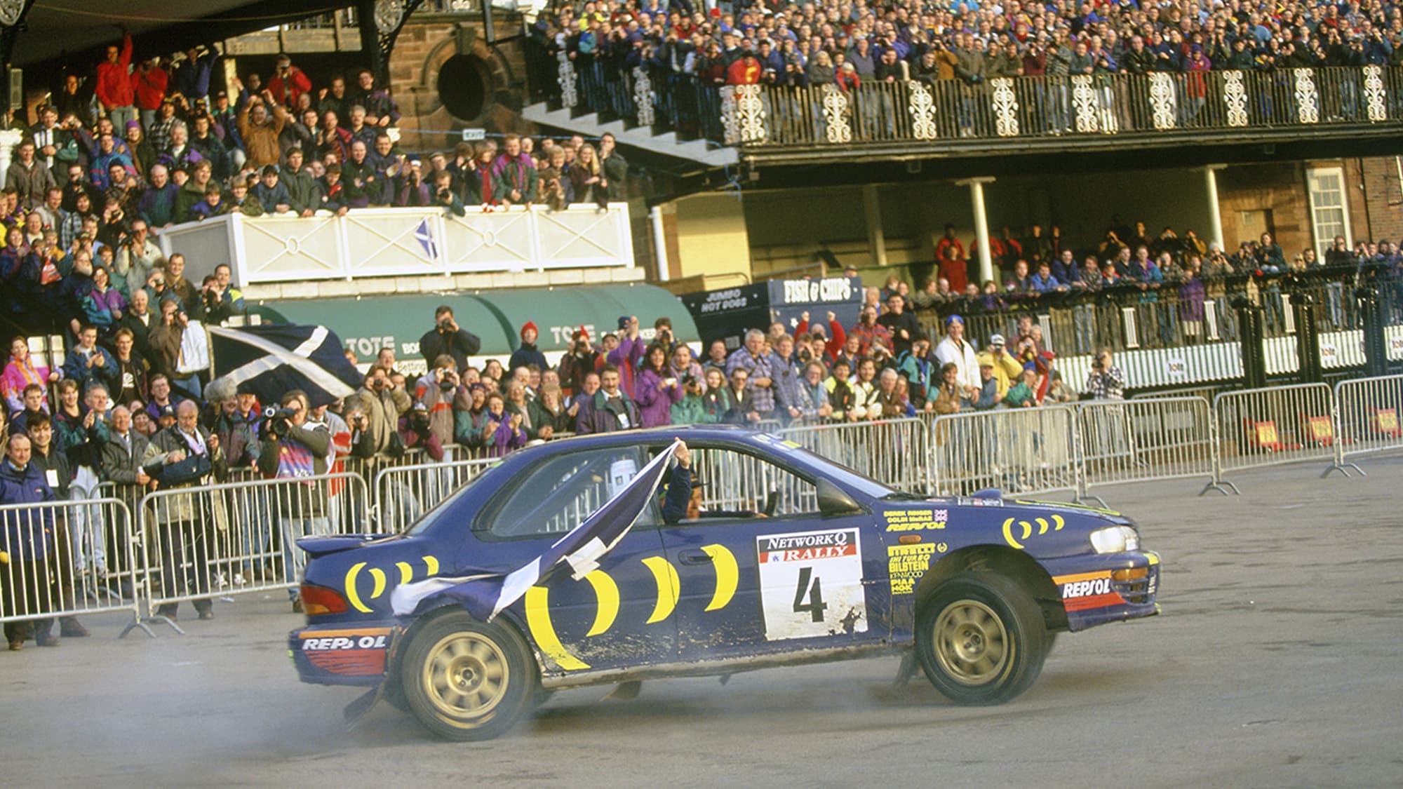 Colin McRae parades in front of the Chester Racecourse crowd after winning the 1995 RAC Rally
