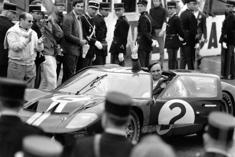 Amon waves to the crowd after winning the 1966 Le Mans in his Ford GT40 MkII