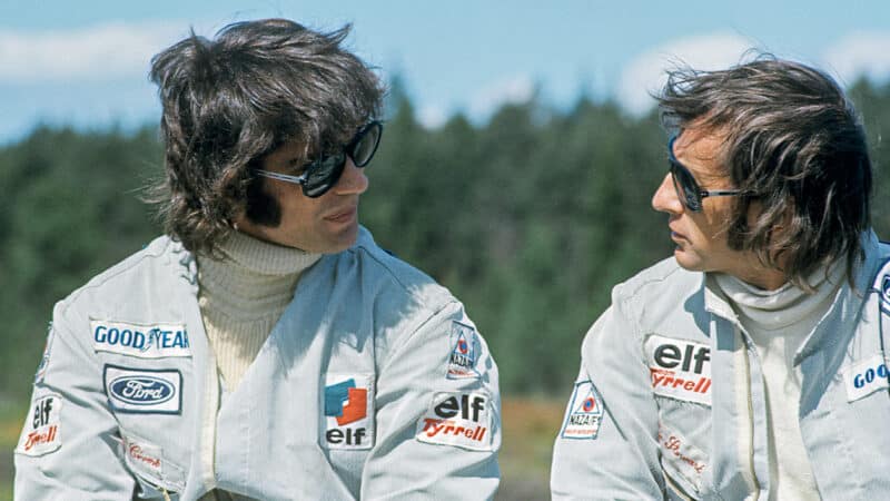 Tyrrell team mates Francois Cevert and Jackie Stewart talk at 1973 F1 Swedish Grand Prix