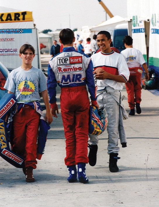 Colin Brown talks to Lewis Hamilton in karting paddock