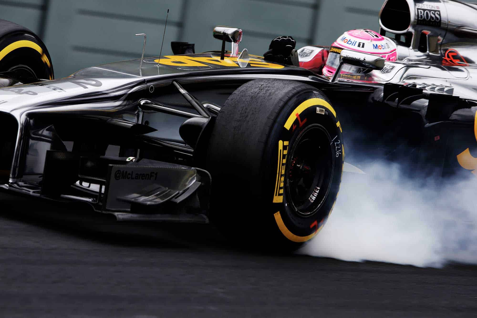 Jenson Button locks up his McLaren-Mercedes at 2014 Brazilian Grand Prix