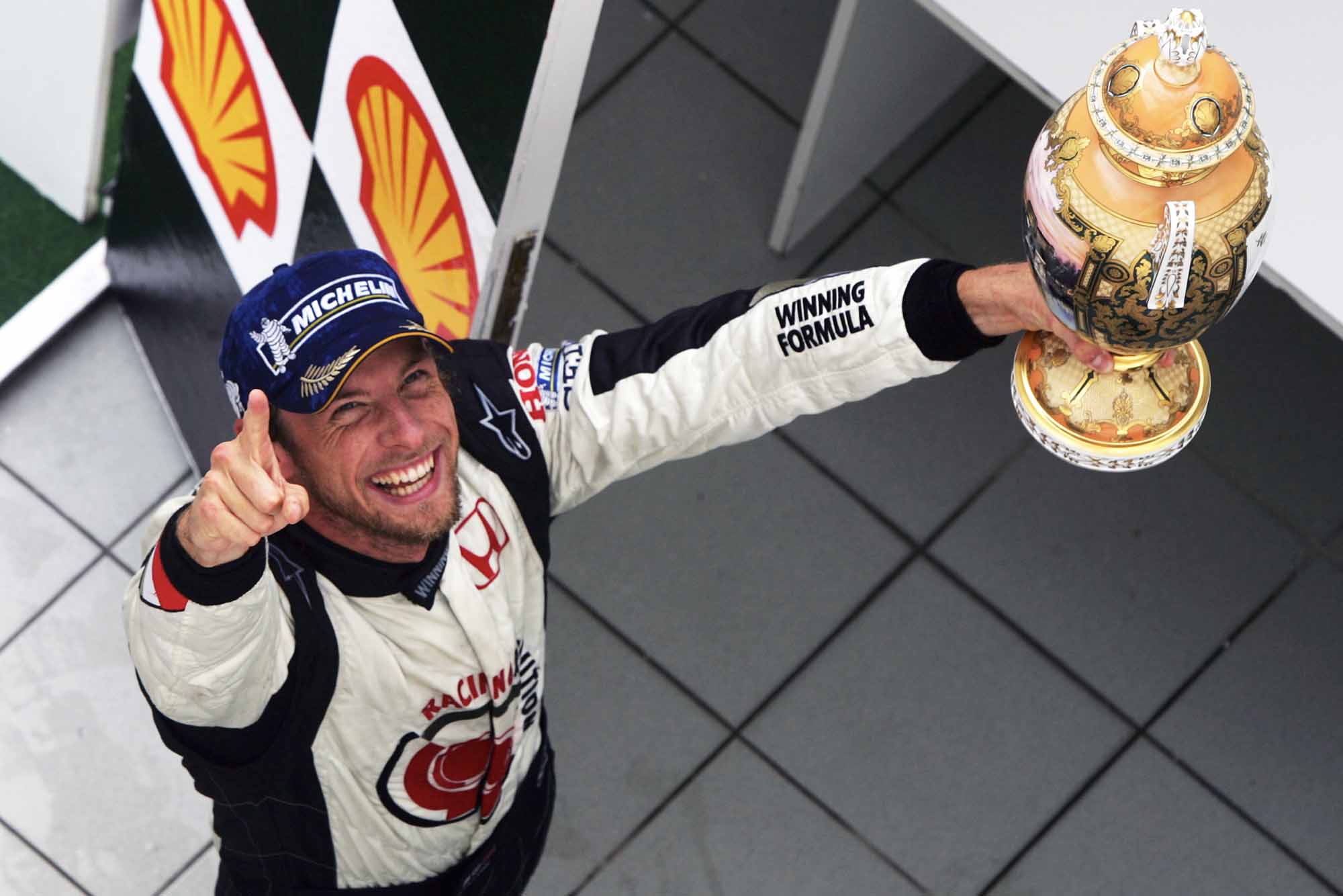 Jenson Button jubilantly holds his trophy aloft after winning 2006 Hungarian Grand Prix