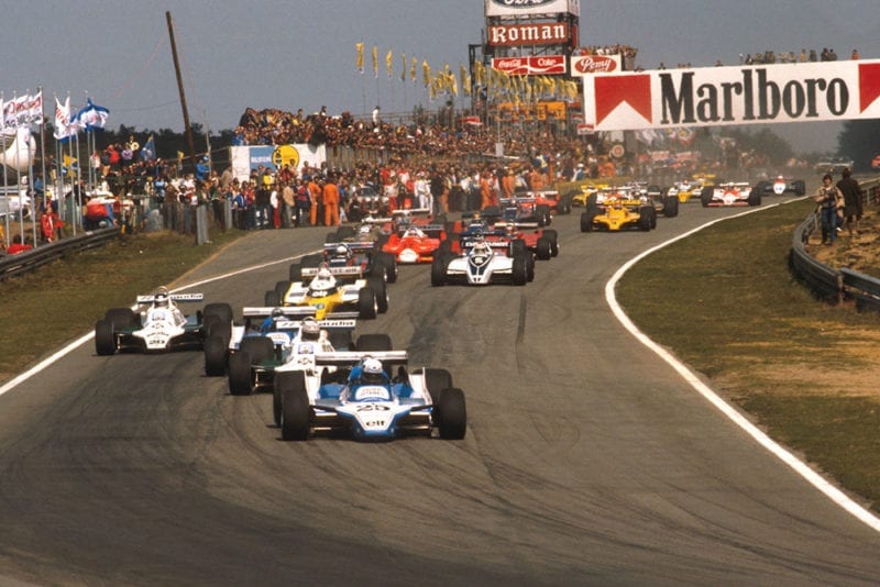 Didier Pironi (Ligier JS11/15 Ford) leads Alan Jones (Williams FW07B Ford), Jacques Laffite (Ligier JS11/15 Ford), Carlos Reutemann (Williams FW07B Ford) and Rene Arnoux (Renault RE20) into the first turn at the start.