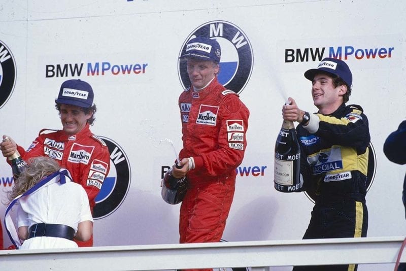 Niki Lauda, 1st position, Alain Prost, 2nd position and Ayrton Senna 3rd position on the podium.