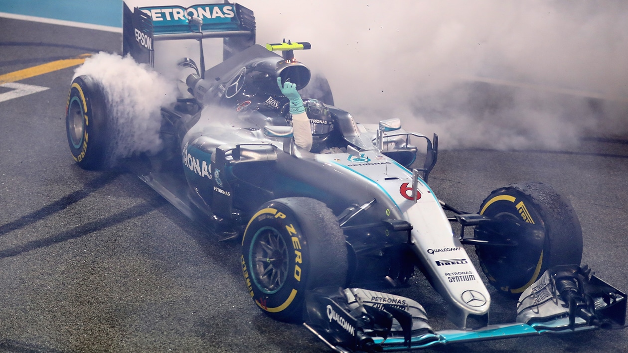 Smoke pours from the tyres of Nico Rosberg Mercedes F1 car as he performs donuts having won the 2016 F1 drivers championship