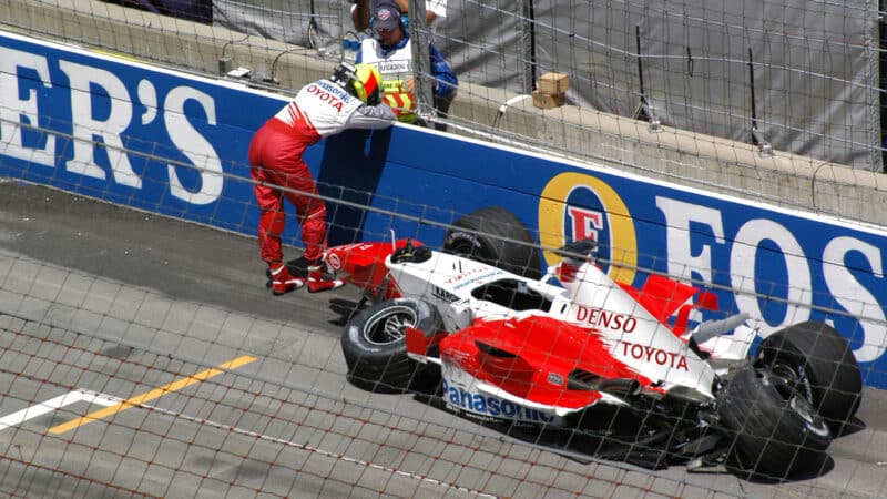 Ralf Schumacher leans on Indianapolis barrier after crashing ahead of 2005 US Grand Prix