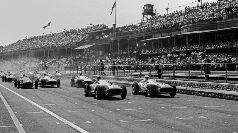 Juan Manuel Fangio and Stirling Moss lead at the start of the 1955 British Grand Prix at Aintree