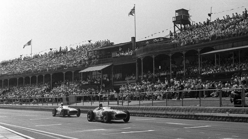 Juan Manuel Fangio leads across the start finish line at Aintree during the 1955 British Grand Prix