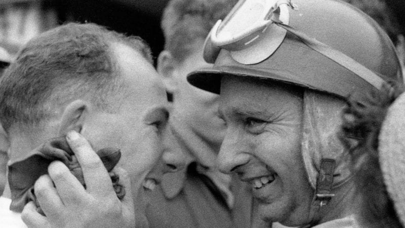 Stirling Moss and Juan Manuel Fangio smile after their 1-2 finish at the 1955 British Grand Prix at Aintree