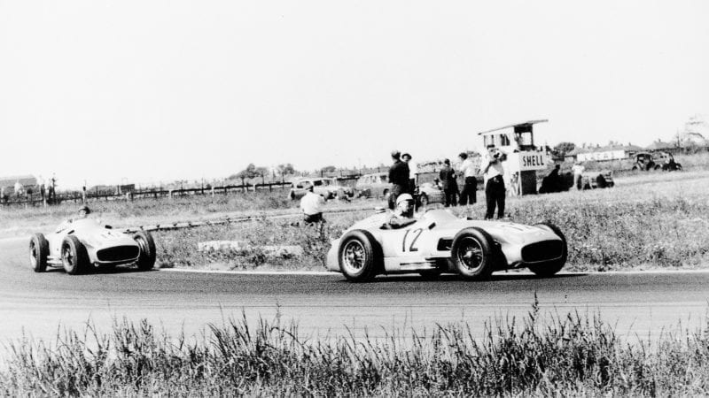 Stirling Moss leads Juan Manuel Fangio in Mercedes W196 R cars at the 1955 F1 British Grand Prix at Aintree
