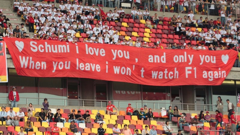 Fans at the 2006 F1 Chinese Grand Prix hold a banner marking Michael Schumacher's retirement form the sport