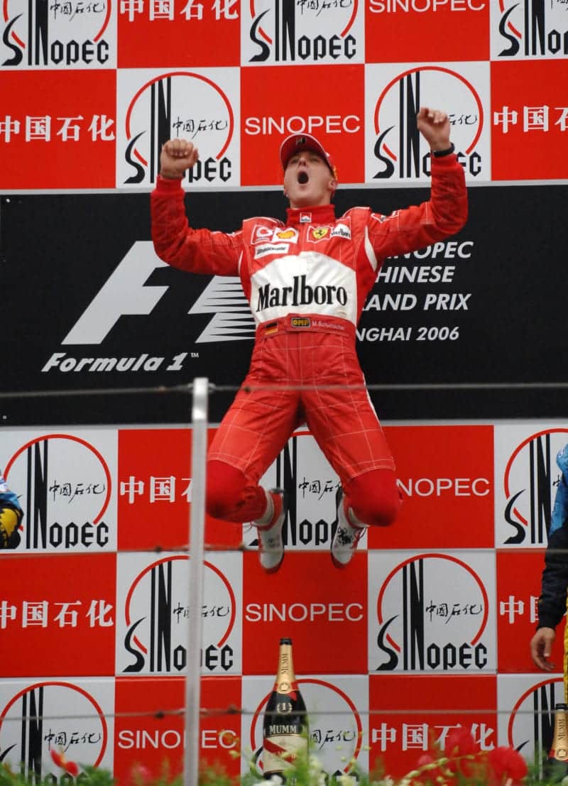 Michael-Schumacher-leaps-on-the-podium-at-the-2006-Chinese-Grand-Prix-after-his-final-91st-F1-win