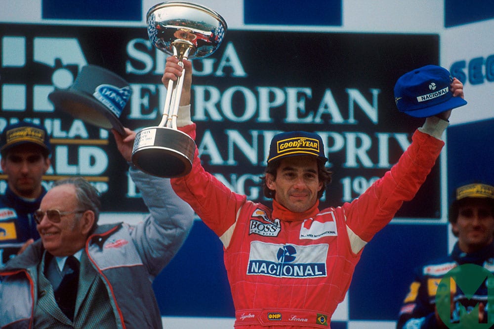 Ayrton Senna celebrates on the podium with Donington circuit owner Tom Wheatcroft