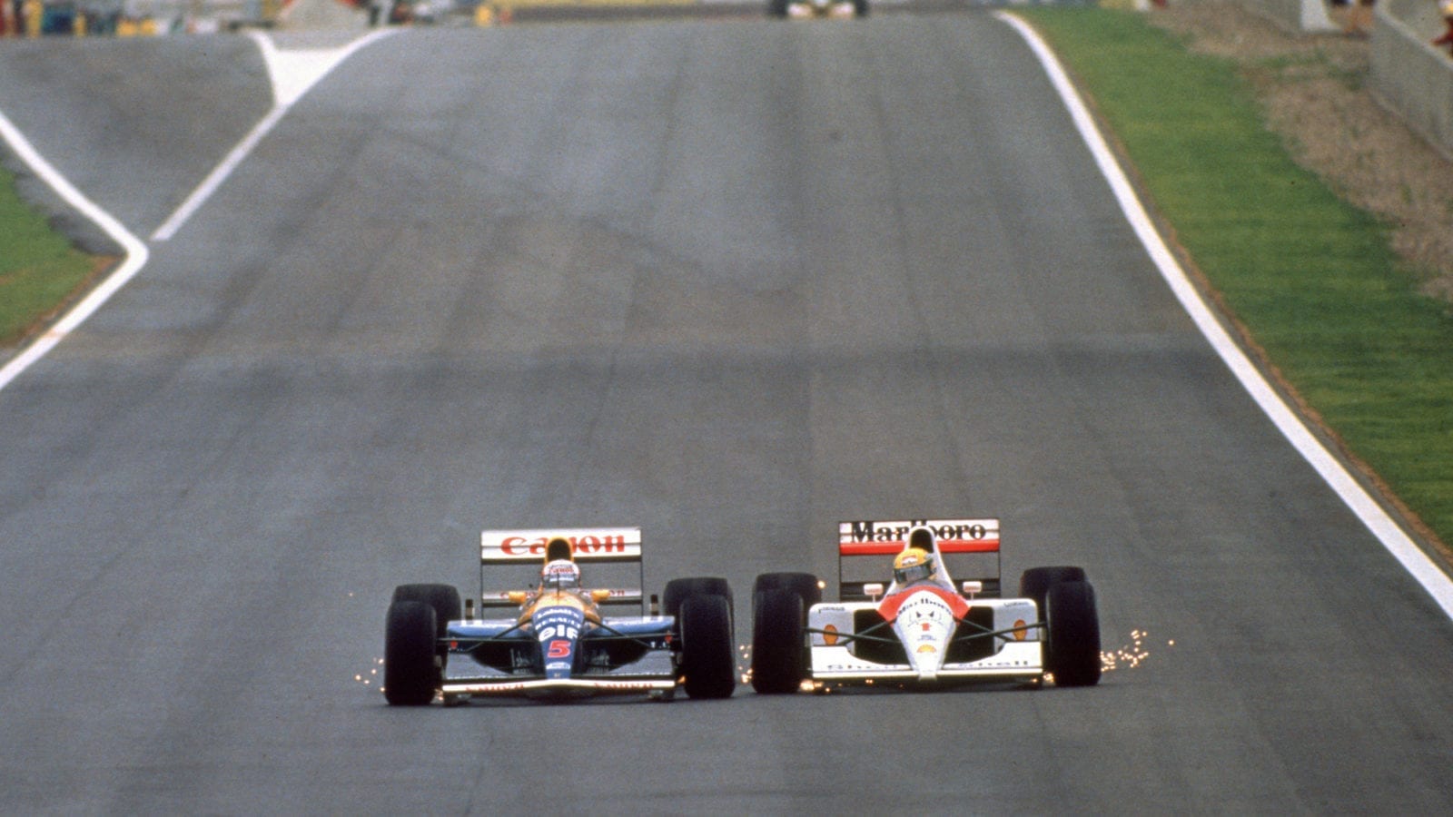 Nigel Mansell and Ayrton Senna are side by side with sparks flying during the 1991 Spanish Grand Prix