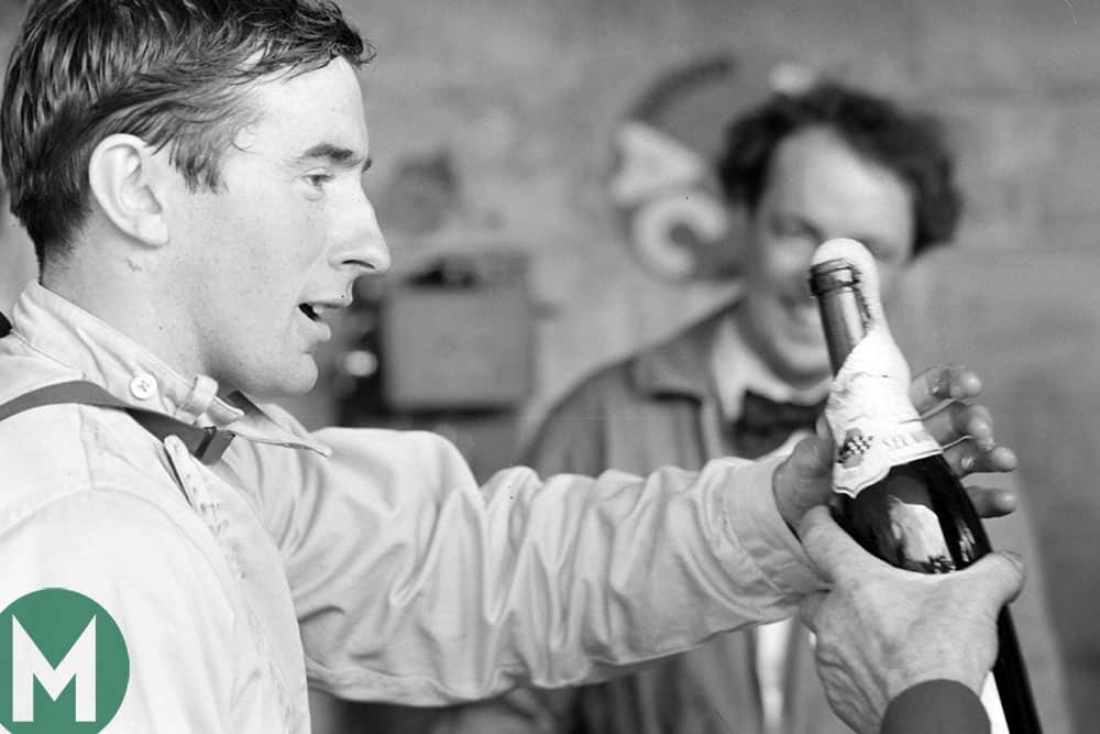 Jackie Stewart celebrates tenth position at the 1965 Le Mans 24 Hours with champagne