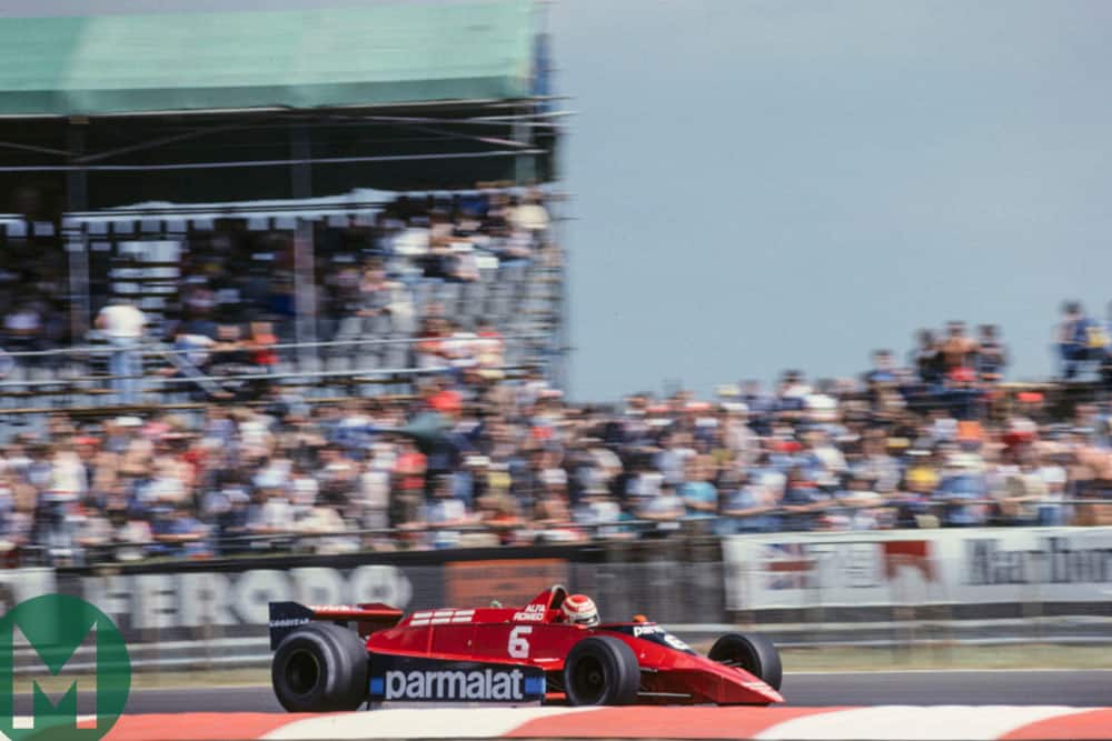 Nelson Piquet in the Brabham-Alfa Romeo speeds past the crowds at Silverstone