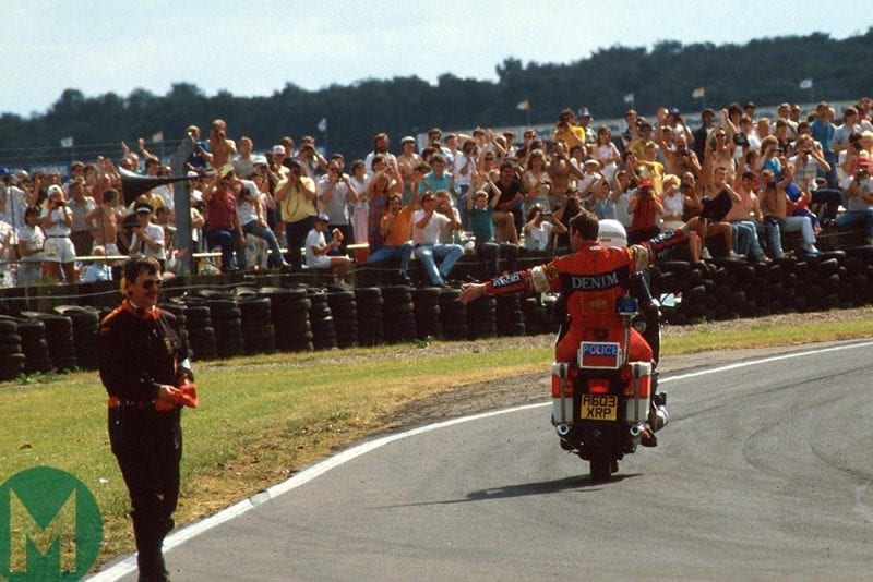 Nigel Mansell returns to the pits on a moped after winning the 1987 British Grand Prix