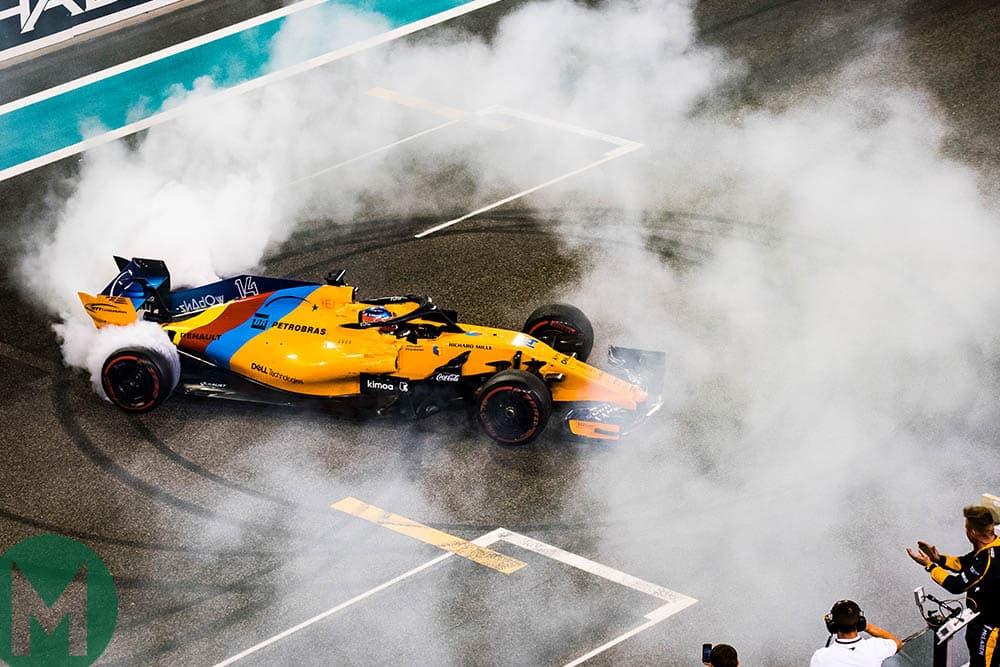 Fernando Alonso in a cloud of tyre smoke at his final grand prix at Abu Dhabi in 2018